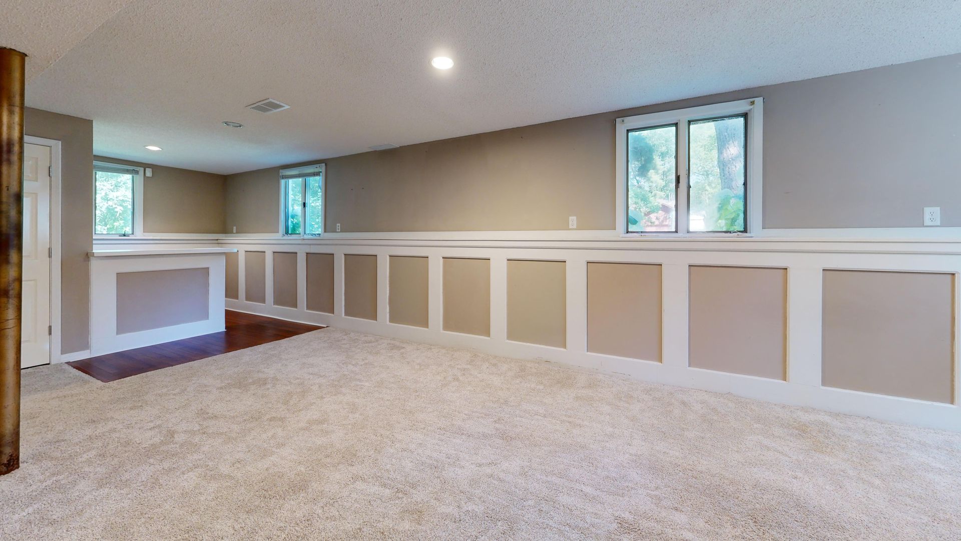 Bright and airy basement with ample natural light and modern decor.